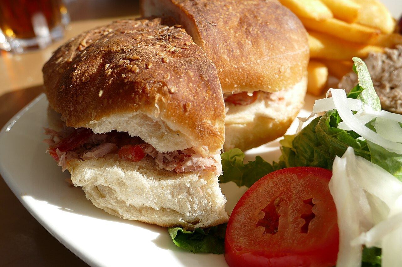 A ftira sandwich filled with tuna and tomato